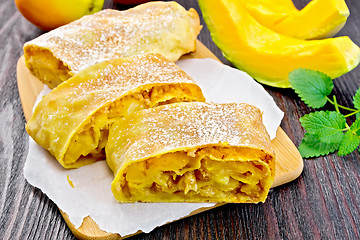 Image showing Strudel pumpkin and apple on dark wooden board