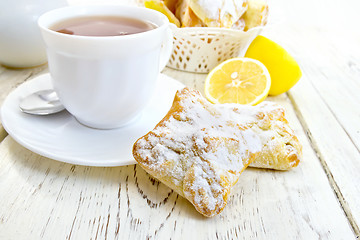 Image showing Cookies lemon with tea on light board