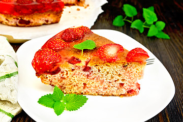 Image showing Pie strawberry with jelly in plate on dark board