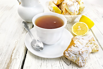 Image showing Tea in white cup with lemon cookies on board