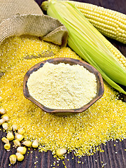 Image showing Flour corn in bowl with grits on dark board