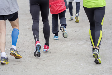 Image showing Group of people running outside on road