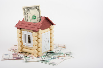 Image showing House stands on the banknotes of Russian rubles, from the roof sticking out of ten US dollars banknote