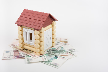 Image showing House stands on the banknotes of Russian rubles, from the roof sticking out of ten US dollars banknote