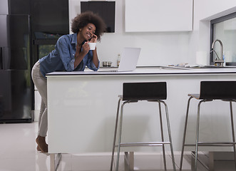 Image showing smiling black woman in modern kitchen