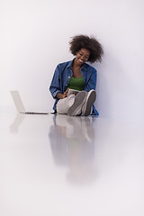 Image showing african american woman sitting on floor with laptop