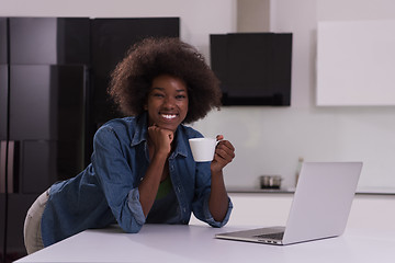 Image showing smiling black woman in modern kitchen