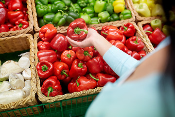 Image showing woman with basket buying peppers at grocery store