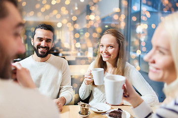 Image showing happy friends meeting and drinking tea