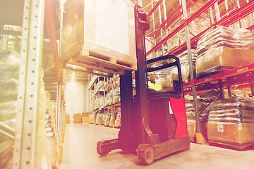 Image showing man on forklift loading cargo at warehouse