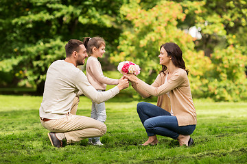 Image showing happy family with flowers in summer park