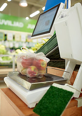 Image showing apples in plastic bag on scale at grocery store