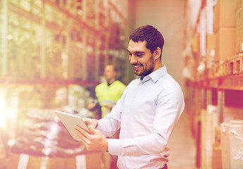 Image showing happy businessman with clipboard at warehouse