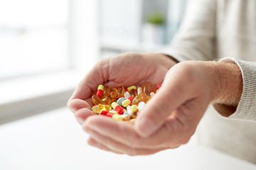 Image showing close up of old man hands holding medicine