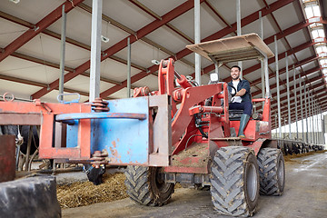 Image showing man or farmer driving tractor at farm