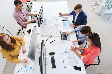 Image showing creative team with computers, blueprint at office