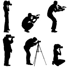 Image showing Set cameraman with video camera. Silhouettes on white background. illustration