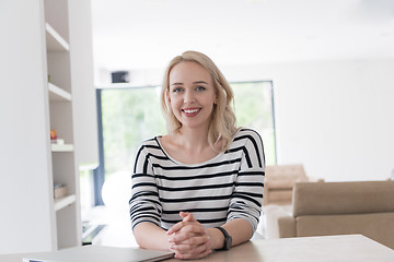 Image showing Young woman with laptop at home