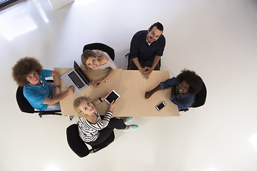 Image showing Multiethnic startup business team on meeting  top view