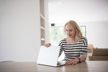 Image showing Young woman with laptop at home