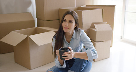 Image showing Thoughtful young woman contemplating her new house