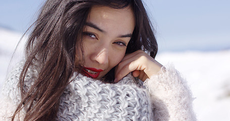 Image showing Happy young asian girl enjoys snowy winter