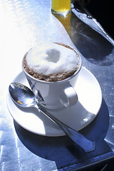 Image showing Cappuccino on sunny table