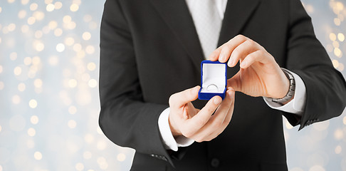 Image showing close up of man with engagement ring in gift box