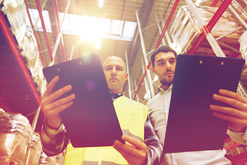 Image showing worker and businessmen with clipboard at warehouse