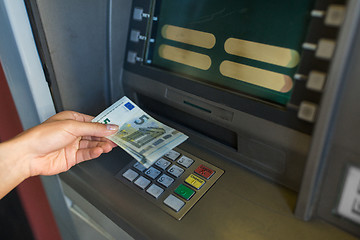 Image showing close up of hand withdrawing money at atm machine