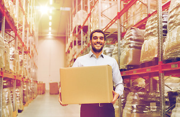 Image showing happy man with cardboard parcel box at warehouse