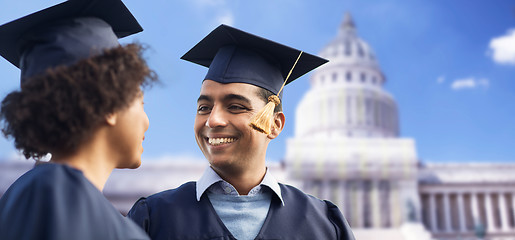 Image showing happy students or bachelors in mortar boards