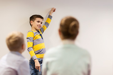 Image showing student boy with marker writing on flip board