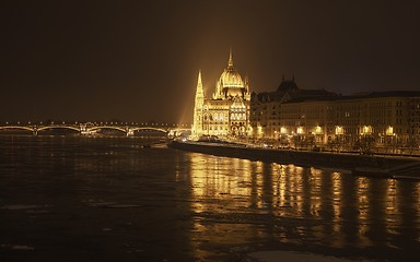 Image showing Parliament at nighttime with icy Danube