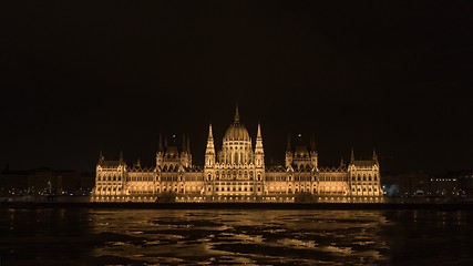 Image showing Parliament at nighttime with icy Danube