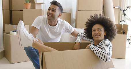 Image showing Smiling young woman in a cardboard carton