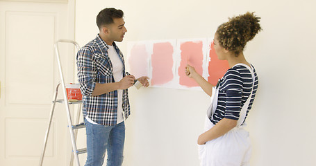 Image showing Young couple debating a new paint color