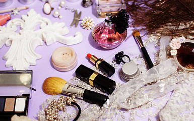 Image showing Jewelry table with lot of girl stuff on it, little mess in cosmetic brushes, women interior concept, perfume elegance things, little princess makeup