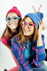 Image showing lifestyle people concept: two pretty stylish modern hipster teen girl having fun together, happy smiling making selfie 