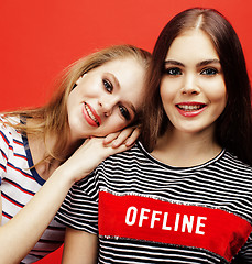 Image showing two best friends teenage girls together having fun, posing emotional on red background, besties happy smiling, lifestyle people concept 
