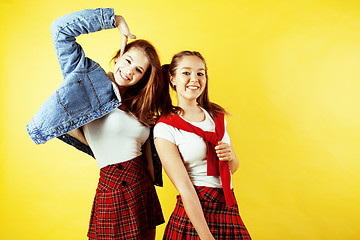 Image showing lifestyle people concept: two pretty school girl having fun on yellow background, happy smiling students