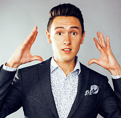 Image showing young pretty business man standing on white background, modern hairstyle, posing emotional, lifestyle people concept 