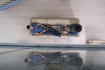 Image showing young multiethnic couple relaxes in the living room top view