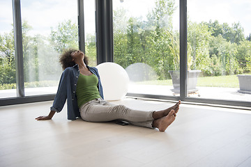 Image showing african american  woman  sitting near window