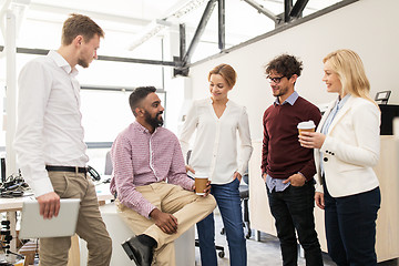 Image showing happy business team drinking coffee at office