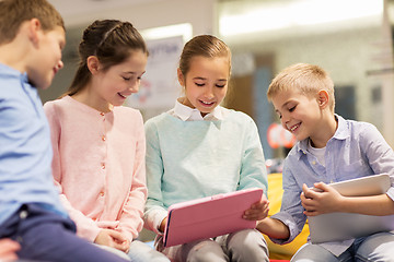 Image showing group of happy children with tablet pc at school