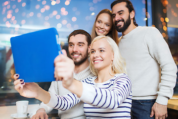 Image showing happy friends with tablet pc taking selfie at cafe