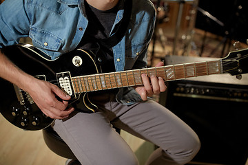 Image showing man playing guitar at studio rehearsal