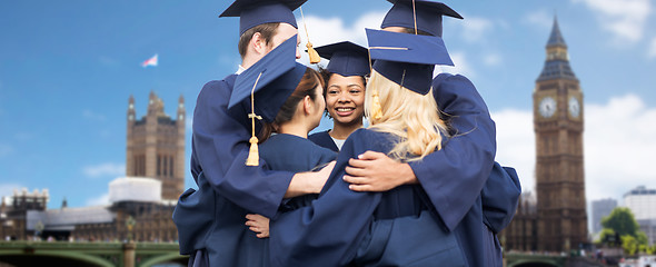 Image showing happy students or bachelors hugging