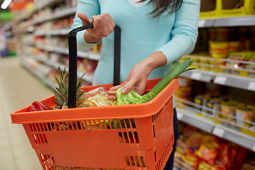 Image showing woman with food basket at grocery or supermarket